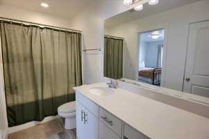 Bathroom with vanity, ensuite bath, recessed lighting, shower / tub combo, and light wood finished floors