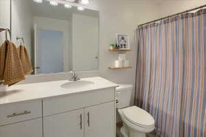 Bathroom featuring vanity and a shower with shower curtain