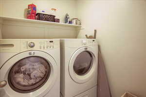Laundry room with washer and clothes dryer