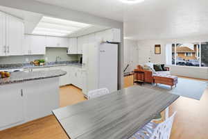 Dining area featuring light wood finished floors and a textured ceiling