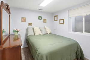 Carpeted bedroom with baseboards