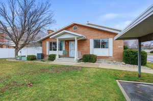 Bungalow-style home featuring brick siding and a chimney