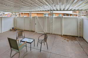 View of fenced patio / terrace with a gate