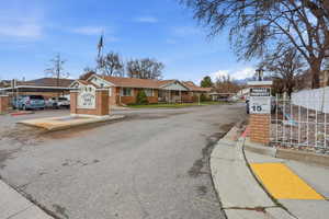 View of asphalt street with curbs, street lighting, and a residential view