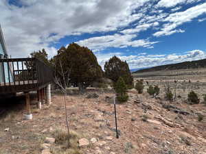View of yard featuring a wooden deck and a view of rural / pastoral area