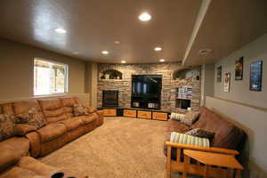Second view of the recreation room with an electric fireplace, built in rock entertainment center and storage drawers.  Wired for projection and surround sound,