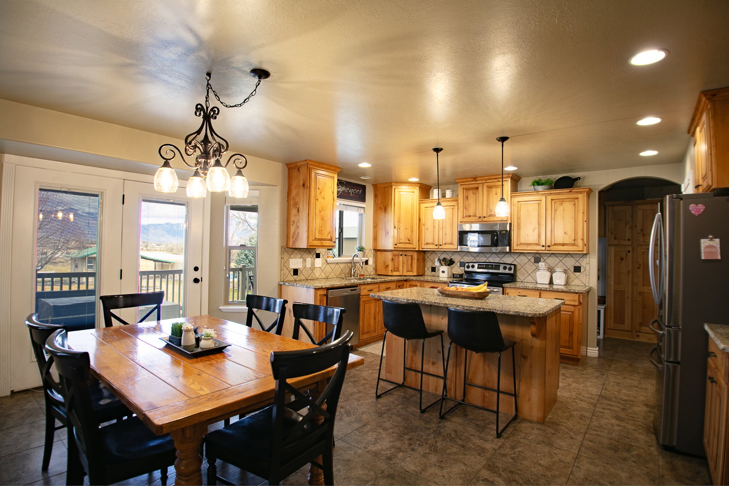 Dining room with arched walkways and hanging lights