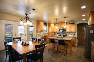 Dining room with arched walkways and hanging lights