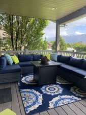 Wooden deck featuring an outdoor living space and a mountain view