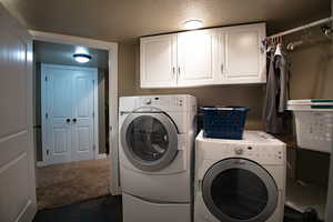 Laundry area with cabinet space, tiled floors, large closets, and mechanical room with two water heaters.