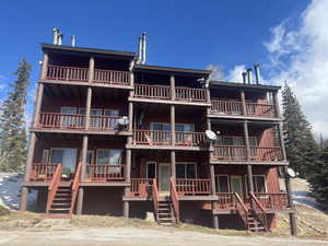 View of front of home featuring stairs and a porch