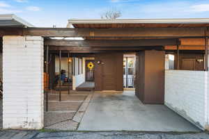 View of exterior entry featuring covered porch