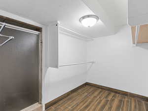 Walk in closet featuring wood tiled floors