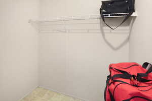 Walk in closet with light floors