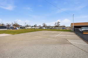 Uncovered parking lot with community basketball court and a residential view