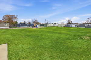View of yard featuring a playground and a residential view