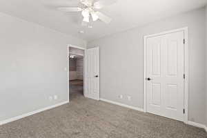 Unfurnished bedroom featuring carpet floors, a textured ceiling, and ceiling fan