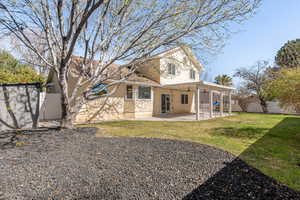 Rear view of property with a fenced backyard, a patio area, stucco siding, and a ceiling fan