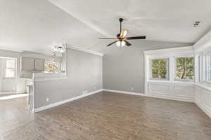 Unfurnished living room with light wood-type flooring and a ceiling fan