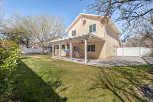 Rear view of property with a patio, stucco siding, a fenced backyard, ceiling fan, and a gate