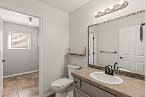 Bathroom featuring vanity and a textured ceiling