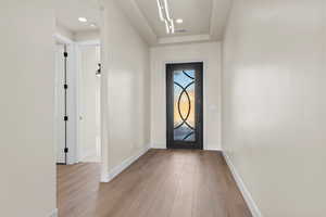 Foyer with light wood-type flooring and baseboards