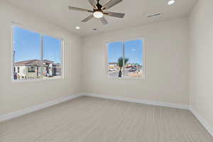 Unfurnished room featuring light colored carpet, ceiling fan, recessed lighting, and plenty of natural light