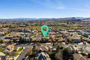 Aerial perspective of suburban area featuring a mountainous background