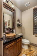 Bathroom featuring vanity and light stone finish flooring