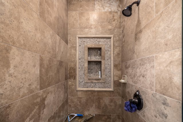 Bathroom view of a tile shower