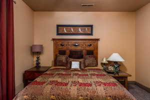 Carpeted bedroom featuring baseboards