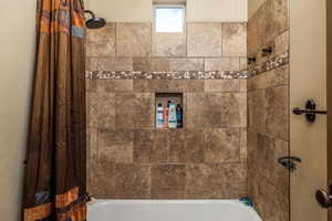 Full bath with shower / bath combination with curtain