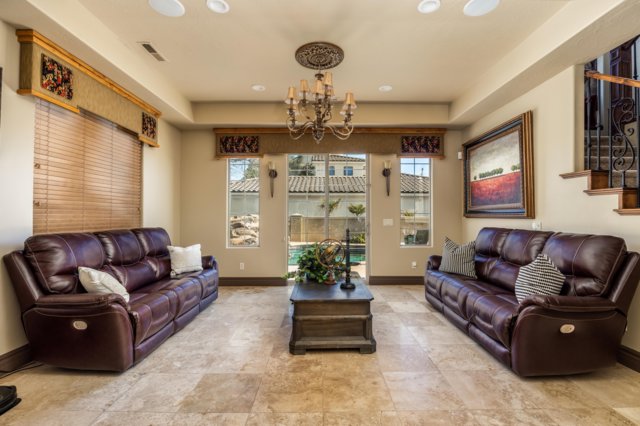 Living area with stairway and a chandelier