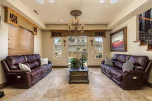 Living area with stairway and a chandelier