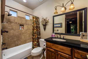 Bathroom featuring vanity and shower / bath combo with shower curtain