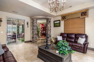 Living area with a chandelier and a tray ceiling