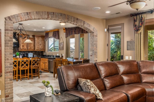Living room featuring arched walkways, recessed lighting, and ceiling fan