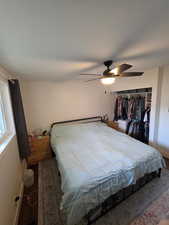 Bedroom with ceiling fan and a closet