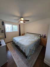 Bedroom featuring dark wood-type flooring and ceiling fan