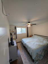 Bedroom featuring dark wood finished floors and a ceiling fan