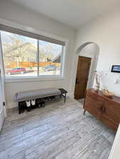 Foyer entrance featuring light wood-style floors and arched walkways