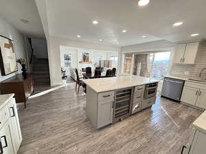 Kitchen with tasteful backsplash, wine cooler, stainless steel appliances, healthy amount of natural light, and recessed lighting