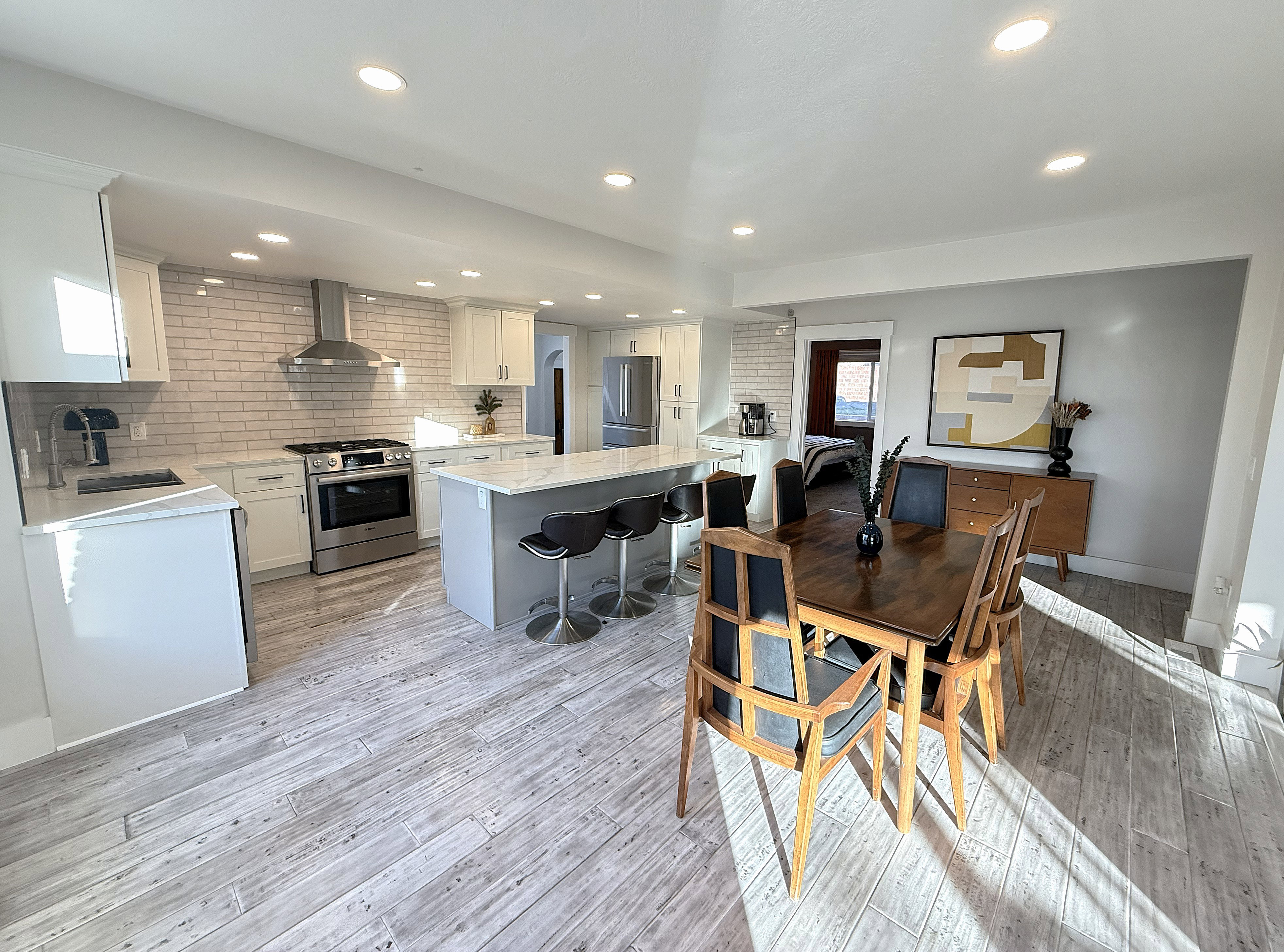 Dining area with light wood finished floors and recessed lighting
