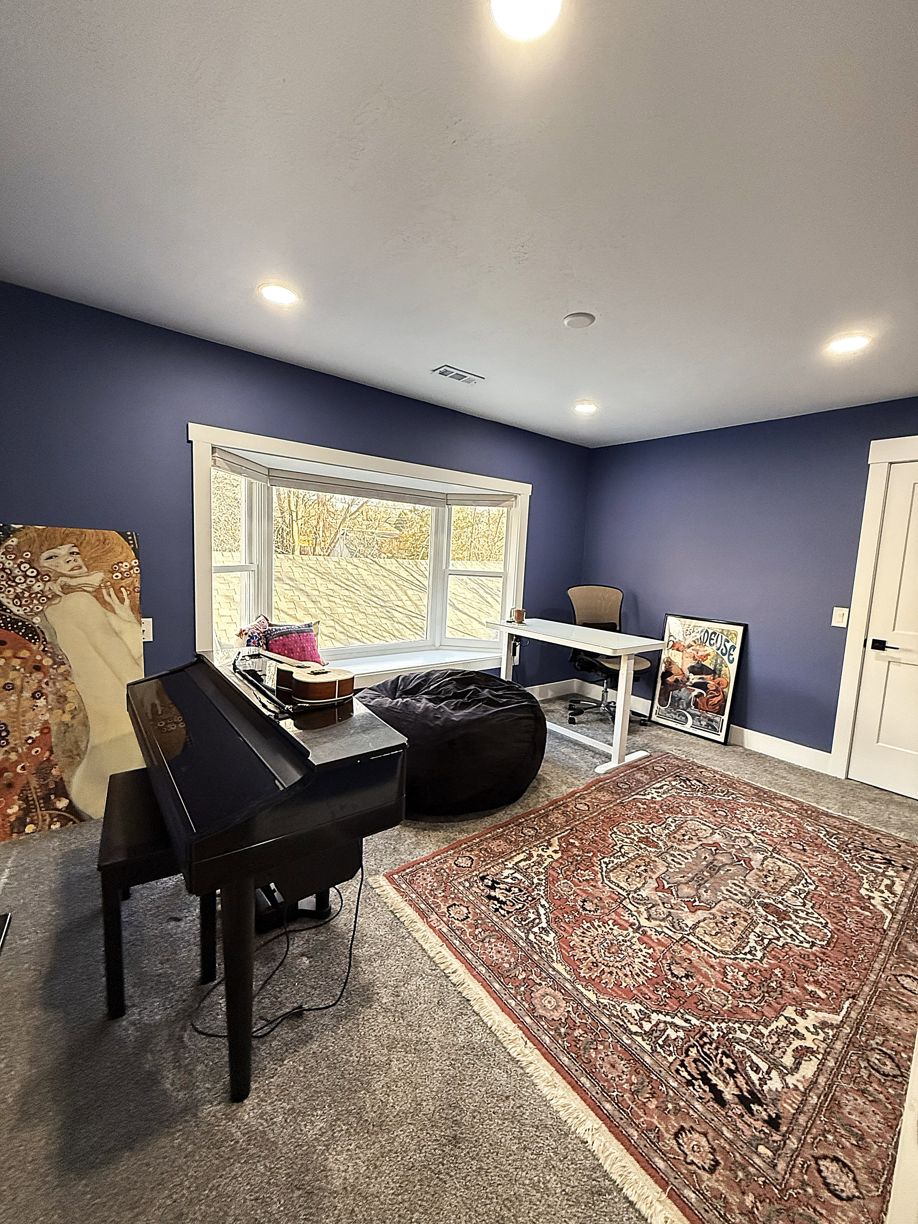 Living area featuring carpet and baseboards