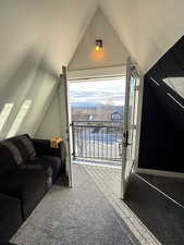 Additional living space featuring light carpet