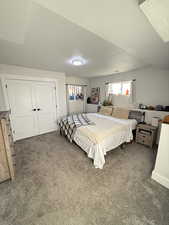 Bedroom featuring dark carpet and a closet