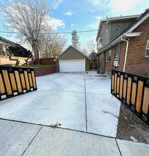 View of yard with a garage and an outbuilding