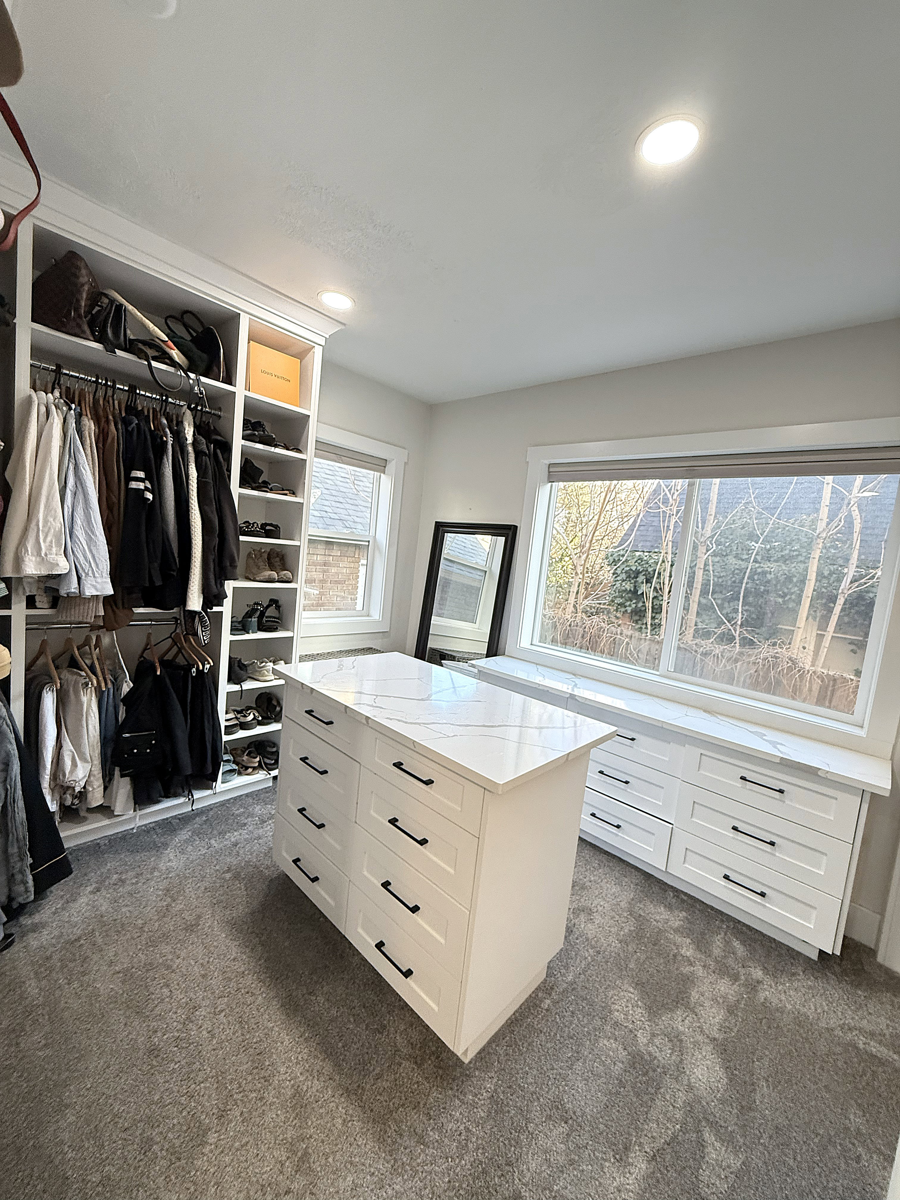 Walk in closet featuring dark colored carpet
