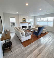 Living room featuring a fireplace, light wood-style floors, and recessed lighting