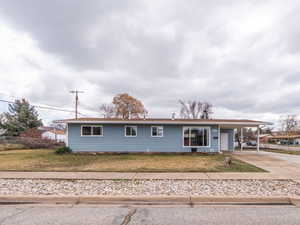 Ranch-style house featuring driveway and an attached carport